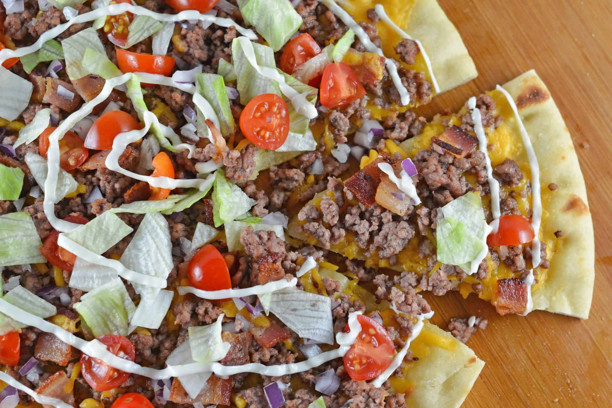 What happens when you take two favorites and mash them together? The best pizza ever! Cheeseburger Pizza! #homemadepizza #cheeseburgerpizza www.savoryexperiments.com