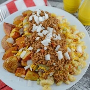 A Garbage Plate is a loaded dish of crispy home fries, hot sauce, macaroni salad and cheeseburgers topped with raw onions, condiments and slices of white bread. #garbageplates www.savoryexperiments.com
