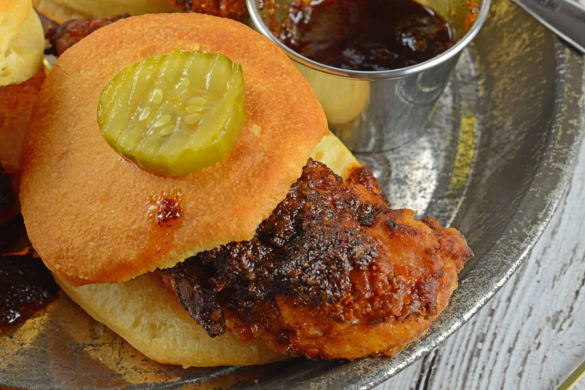 Nashville Hot Chicken Sliders are perfect as a dinner or appetizer. Crispy fried chicken dredged in spicy sauce served on buttermilk biscuits with pickles. #nashvillehotchicken #sliderrecipes www.savoryexperiments.com