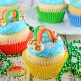 Rainbow Cupcakes are super easy and cute. The perfect cupcake for St. Patrick's Day, children's birthday parties or any random day of the week! #rainbowcupcakes #stapatricksdaydesserts www.savoryexperiments.com