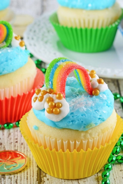 Rainbow Cupcakes are super easy and cute. The perfect cupcake for St. Patrick's Day, children's birthday parties or any random day of the week! #rainbowcupcakes #stapatricksdaydesserts www.savoryexperiments.com