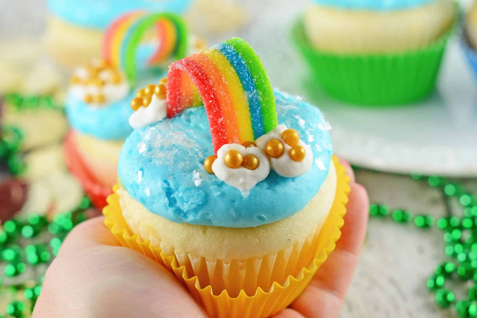 Rainbow Cupcakes are super easy and cute. The perfect cupcake for St. Patrick's Day, children's birthday parties or any random day of the week! #rainbowcupcakes #stapatricksdaydesserts www.savoryexperiments.com