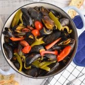 overhead of steamed mussels in a large pot