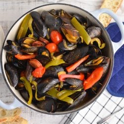 overhead of steamed mussels in a large pot