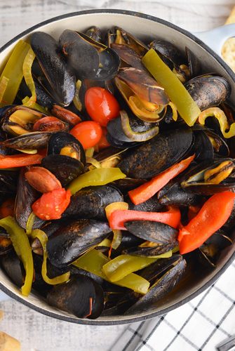 overhead of steamed mussels in a large pot