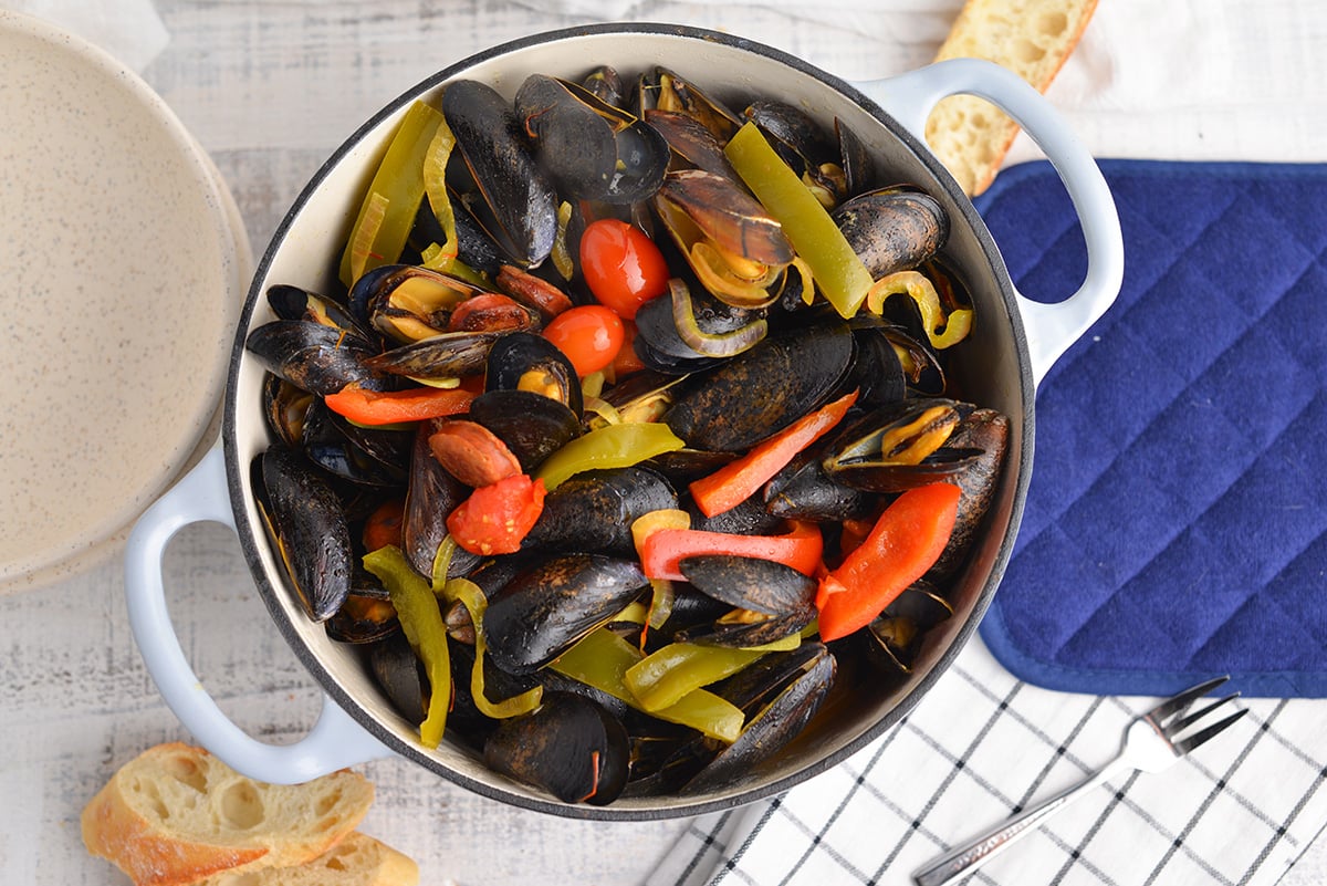 overhead of steamed mussels in a large pot