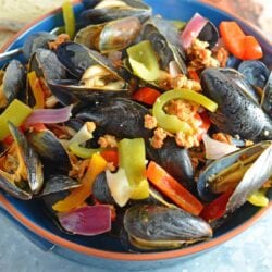 Chorizo Mussels are succulent, luscious, tender Mussels in a savory butter, chorizo wine sauce. It's SO good, it's slurp-worthy. Crusty bread for sopping up broth is a must!