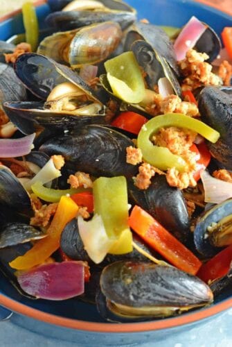 Chorizo Mussels are succulent, luscious, tender Mussels in a savory butter, chorizo wine sauce. It's SO good, it's slurp-worthy. Crusty bread for sopping up broth is a must!