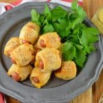 Pigs in a Blanket are great, but what if you made them into CHEESY pigs in a blanket? Serve with homemade creamy honey mustard sauce!