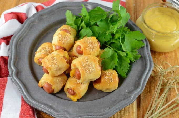 Pigs in a Blanket are great, but what if you made them into CHEESY pigs in a blanket? Serve with homemade creamy honey mustard sauce!