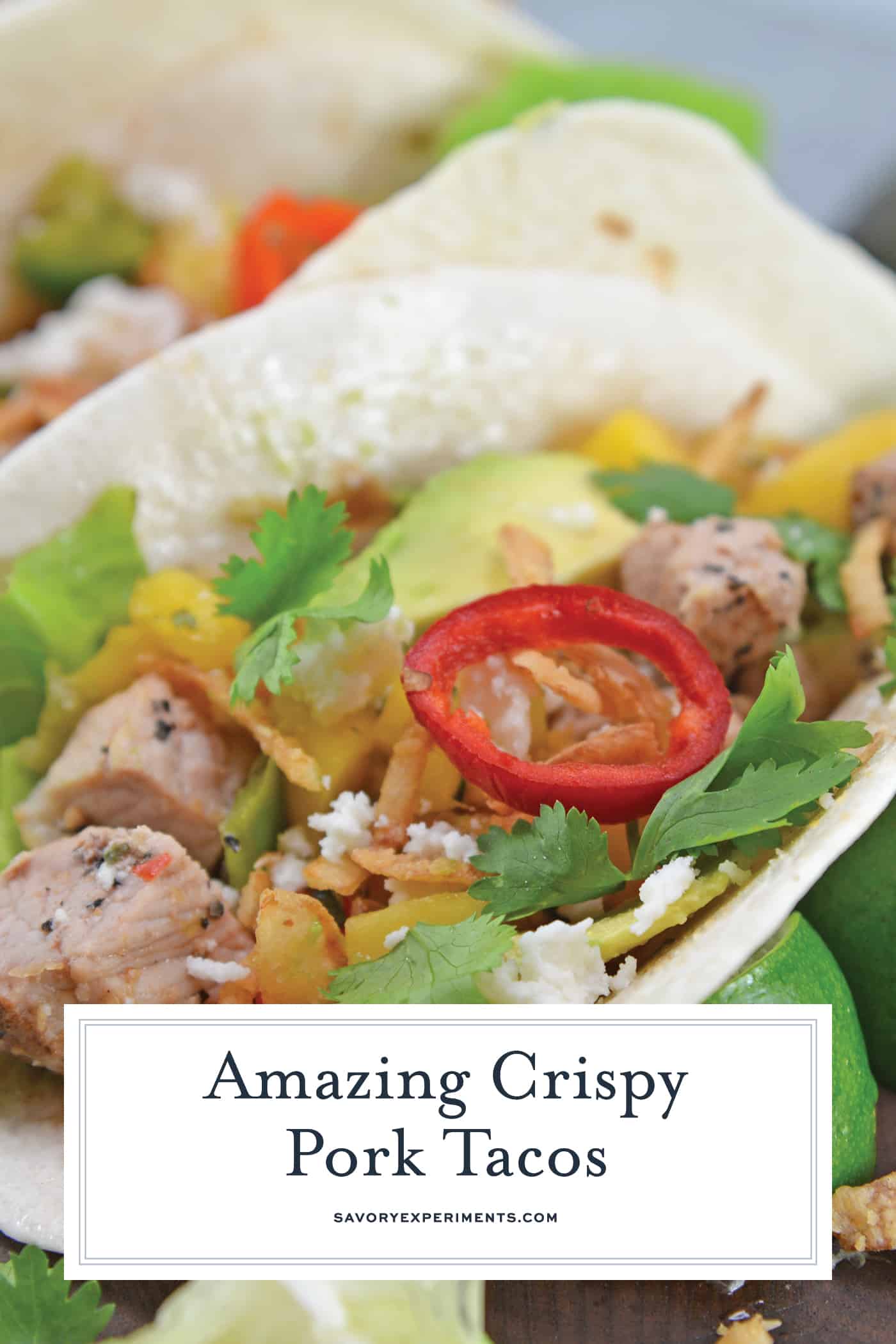 Crispy Pork Tacos are soft tacos filled with mango salsa, cool avocado, crumbly queso fresco, butter lettuce and crispy onion straws. #porktacos #streettacos #homemadetacos www.savoryexperiments.com