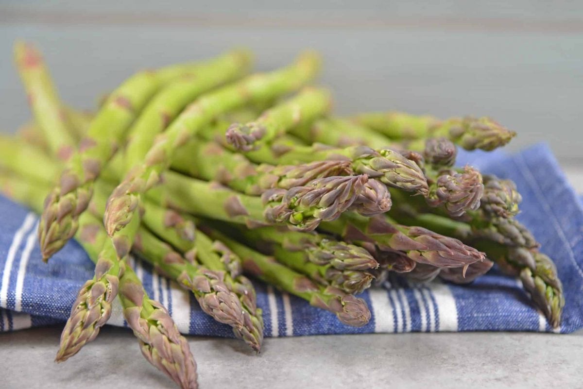 Pickled Asparagus Salad is made with blanched asparagus marinated in a vinaigrette and tossed with water chestnuts, roasted red pepper and almonds.