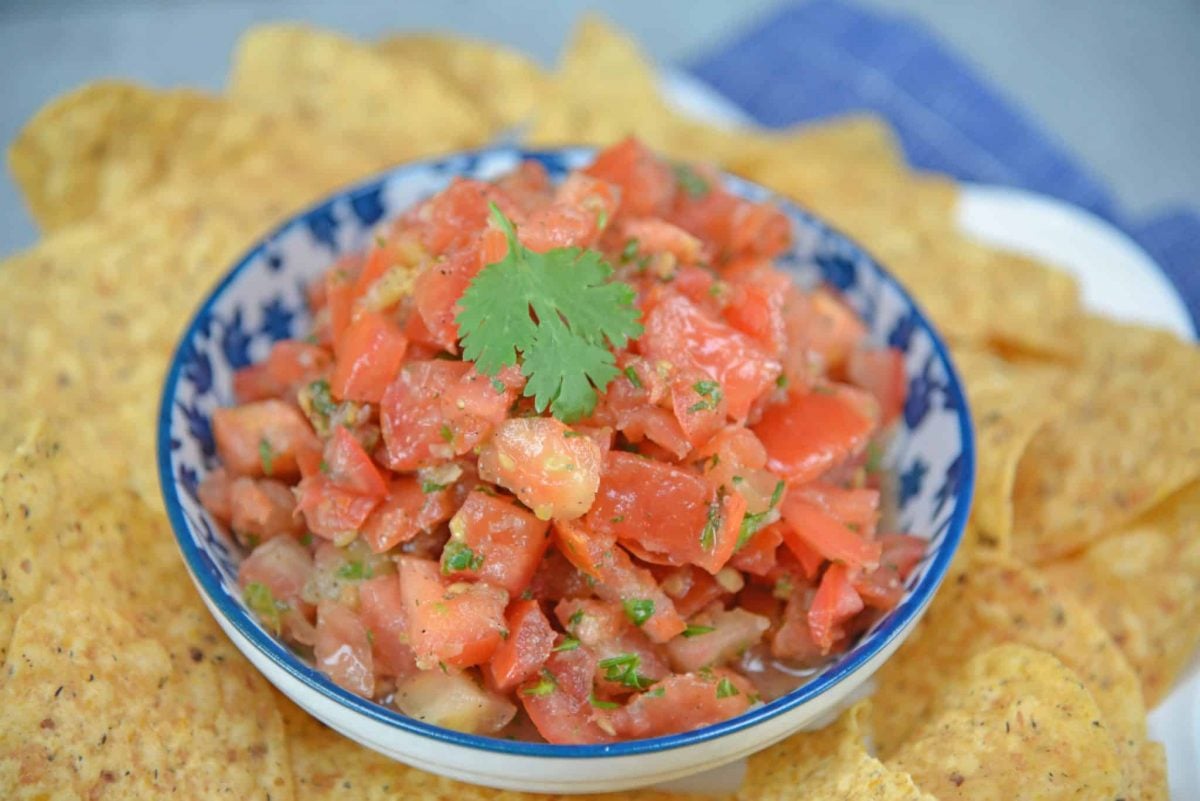 Pico de Gallo, also known as salsa fresca, is made from fresh tomato, onion, cilantro, hot pepper and lime juice. Perfect with tortilla chips! #picodegallo #homemadesalsa www.savoryexperiments.com