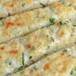 Cheesy Garlic Bread is made with a blend of cheese, cream cheese, garlic and seasonings to make the BEST garlic bread you've ever tasted!