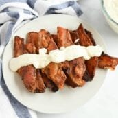 chicken fried bacon on a white platter