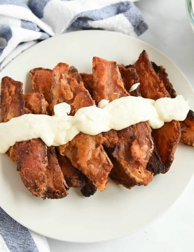 chicken fried bacon on a white platter