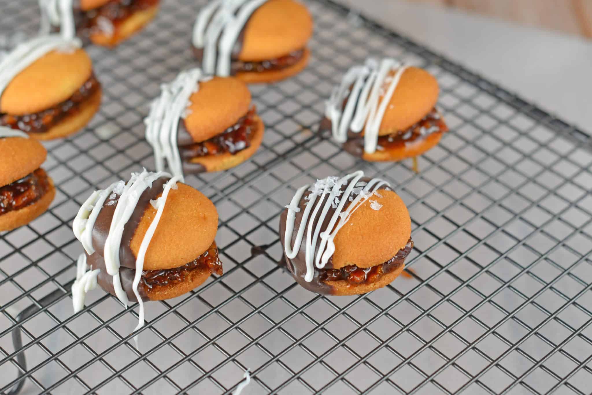 Chocolate Bacon Jam Cookies are an unexpected cookie sandwich filled with a sweet bacon jam and then dipped in dark chocolate and sprinkled with sea salt.