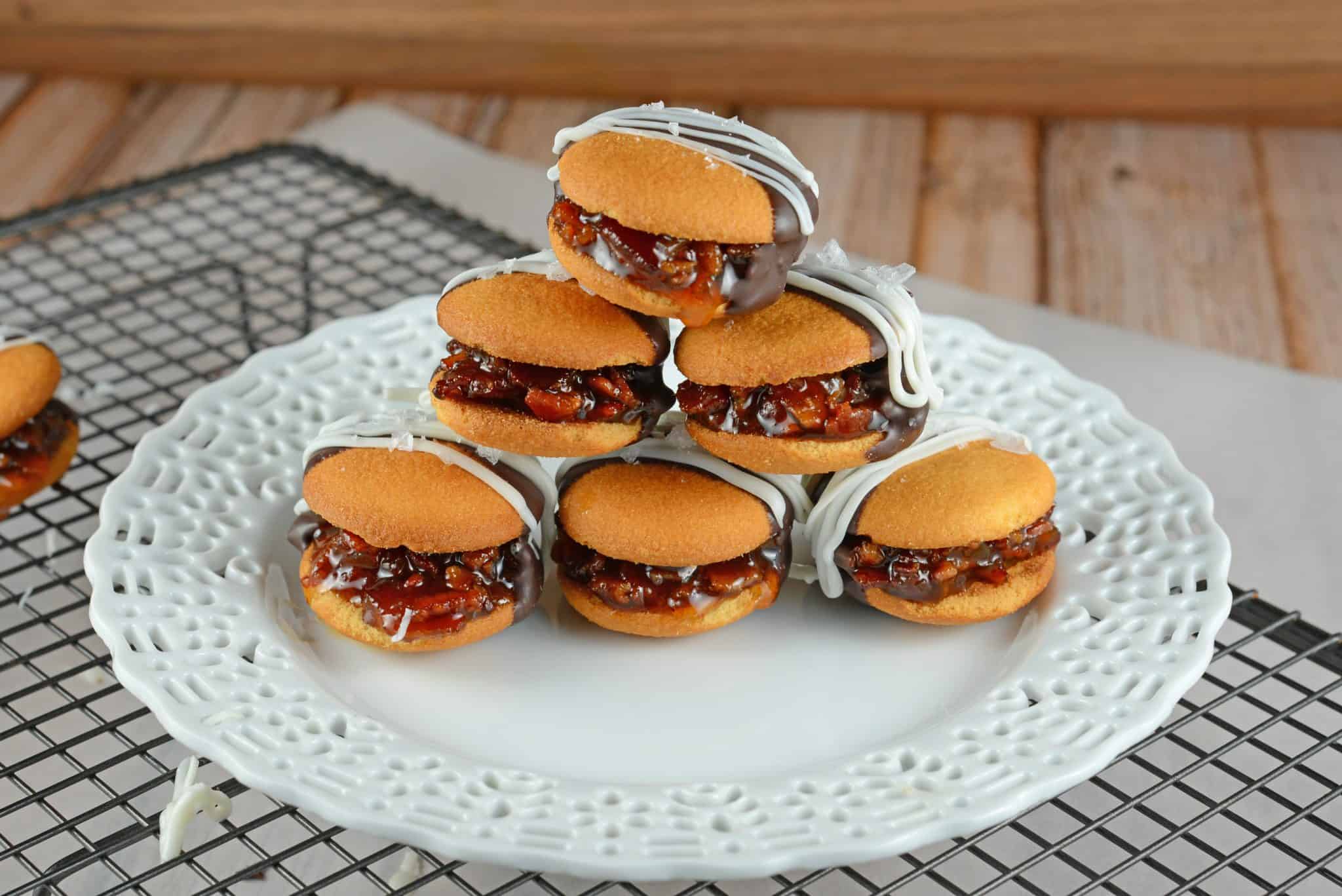 Chocolate Bacon Jam Cookies are an unexpected cookie sandwich filled with a sweet bacon jam and then dipped in dark chocolate and sprinkled with sea salt.