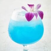 Sparkling Blue Hawaiian Cocktail topped with an orchid