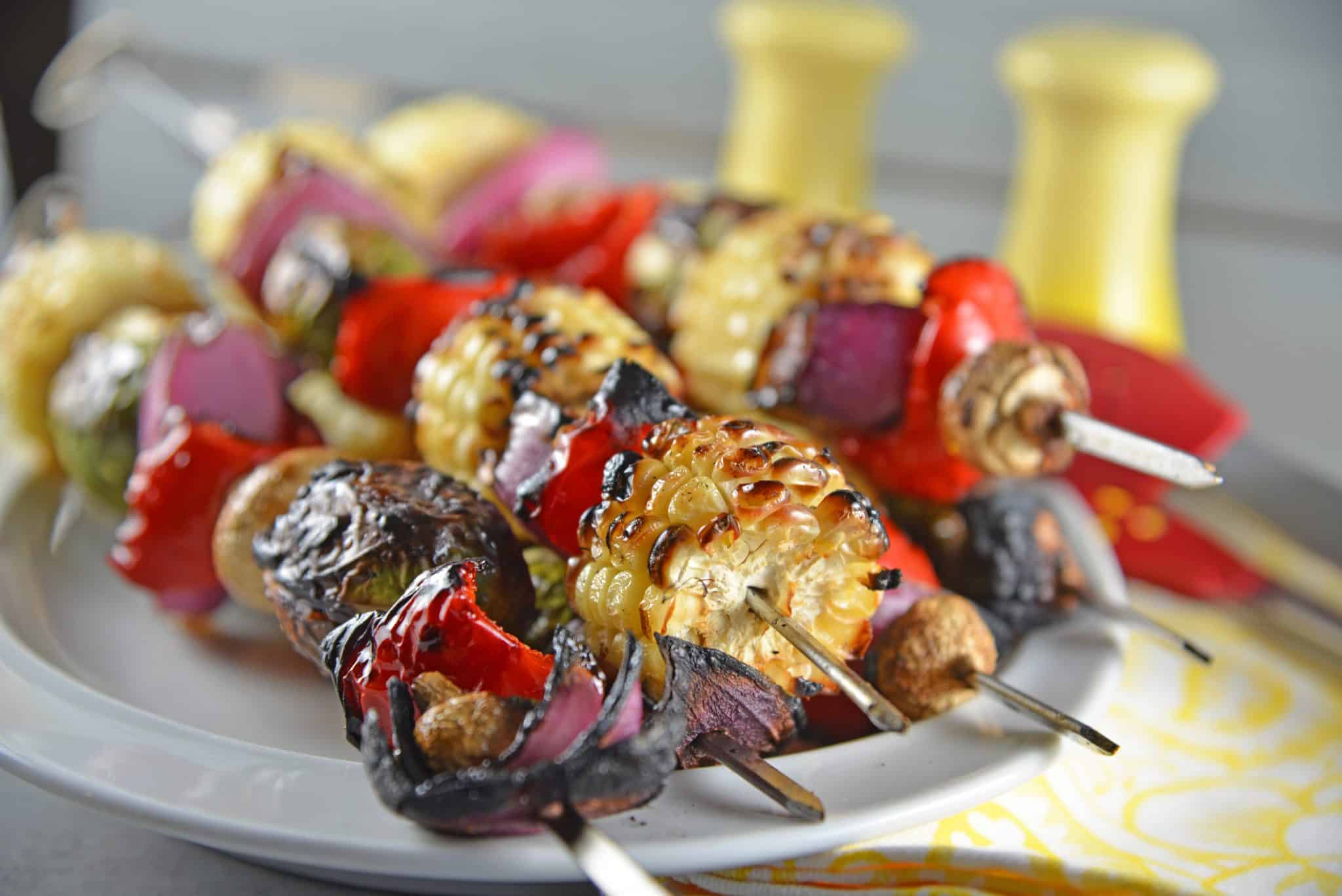 Spicy Honey Vegetable Kabobs are brightly colored skewered grilled vegetables with a sweet and spicy sauce. The perfect side dish for any grilled meal!