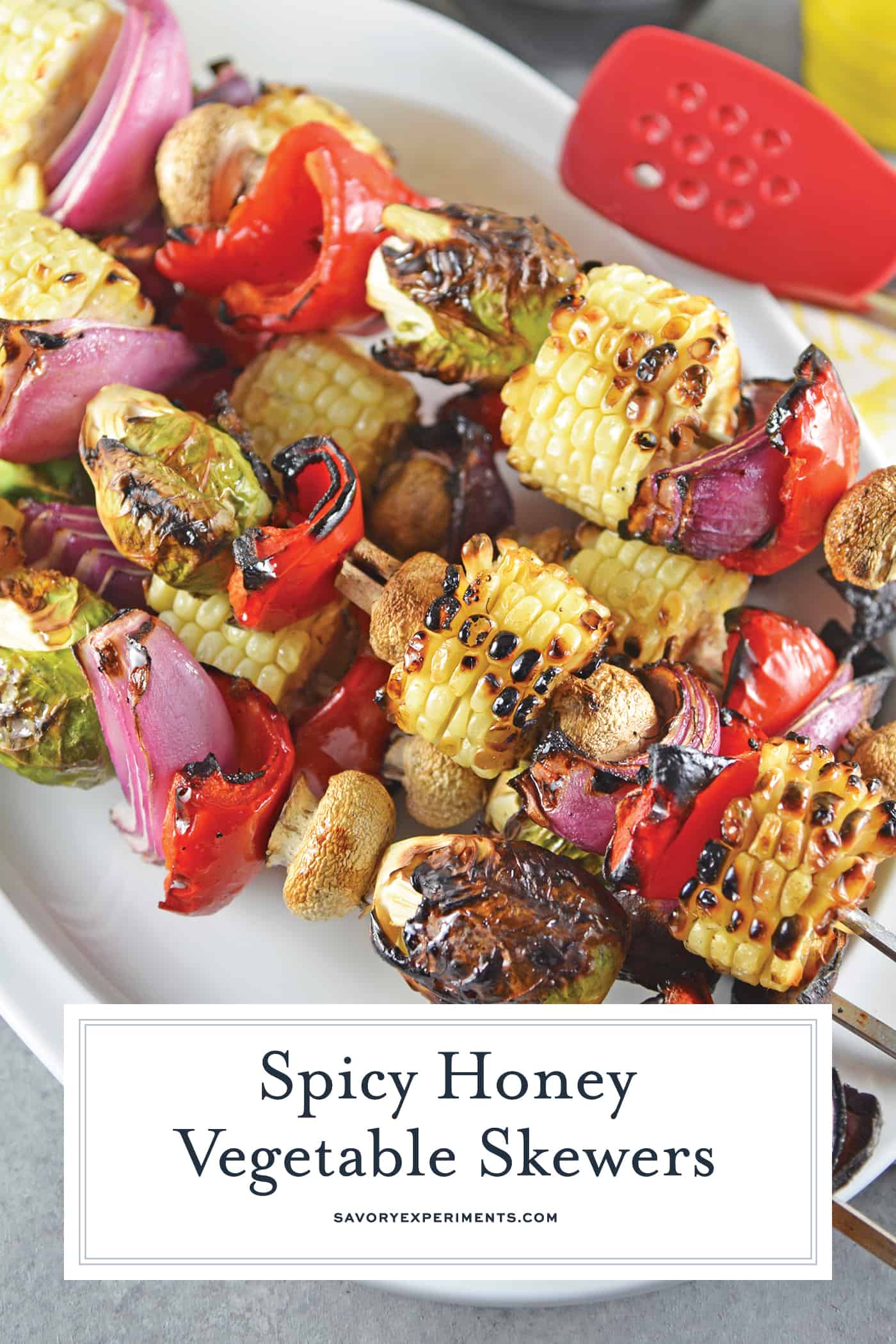 Spicy Honey Vegetable Kabobs are brightly colored skewered grilled vegetables with a sweet and spicy sauce. The perfect side dish for any grilled meal! #vegetablekabobs #grilledvegetables www.savoryexperiments.com