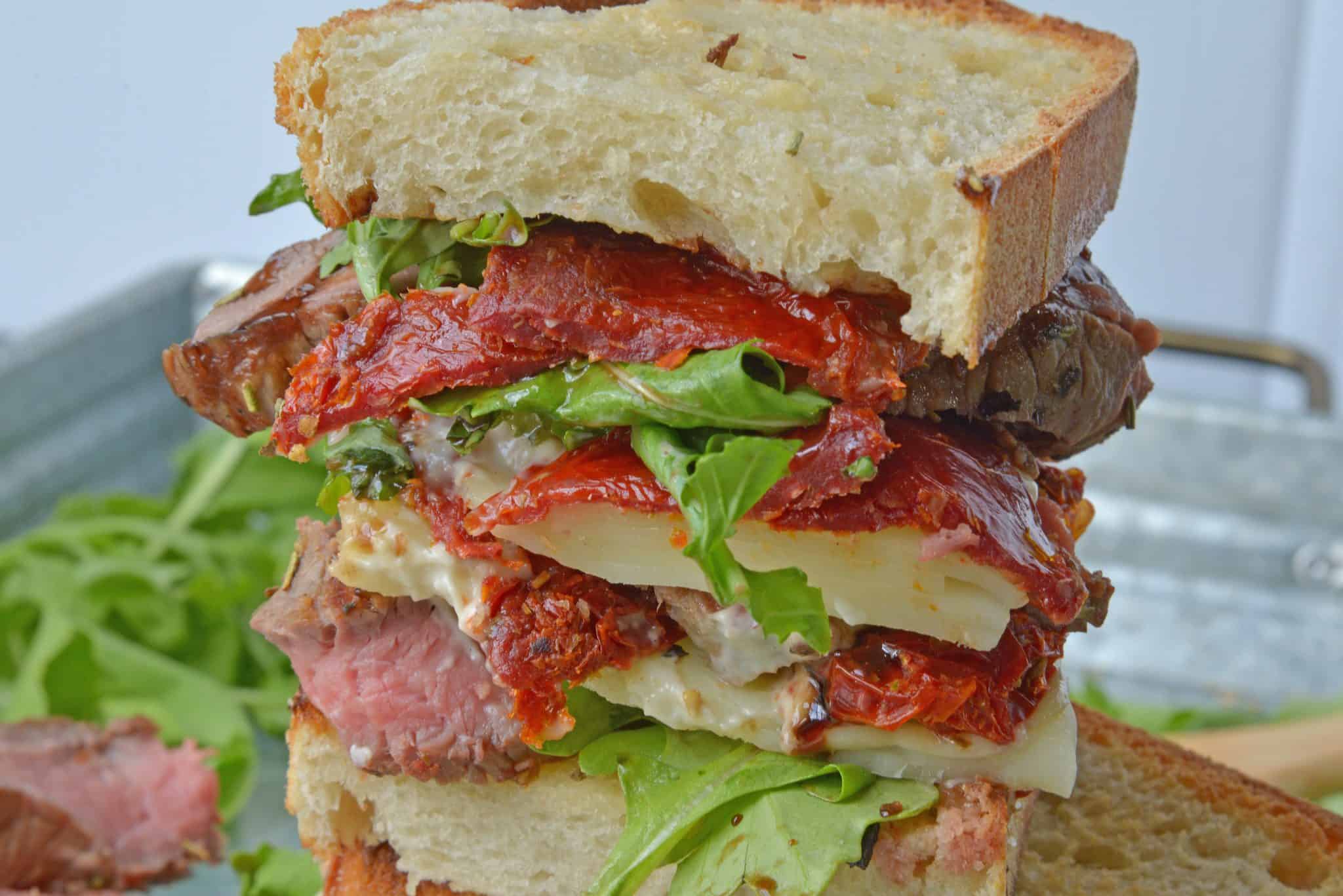 Insane Steak Sandwiches are gourmet sandwiches, seasoned to perfection with zesty Italian herbs and toppings. The best steak sandwich recipe ever! #steaksandwiches #gourmetsandwiches www.savoryexperiments.com