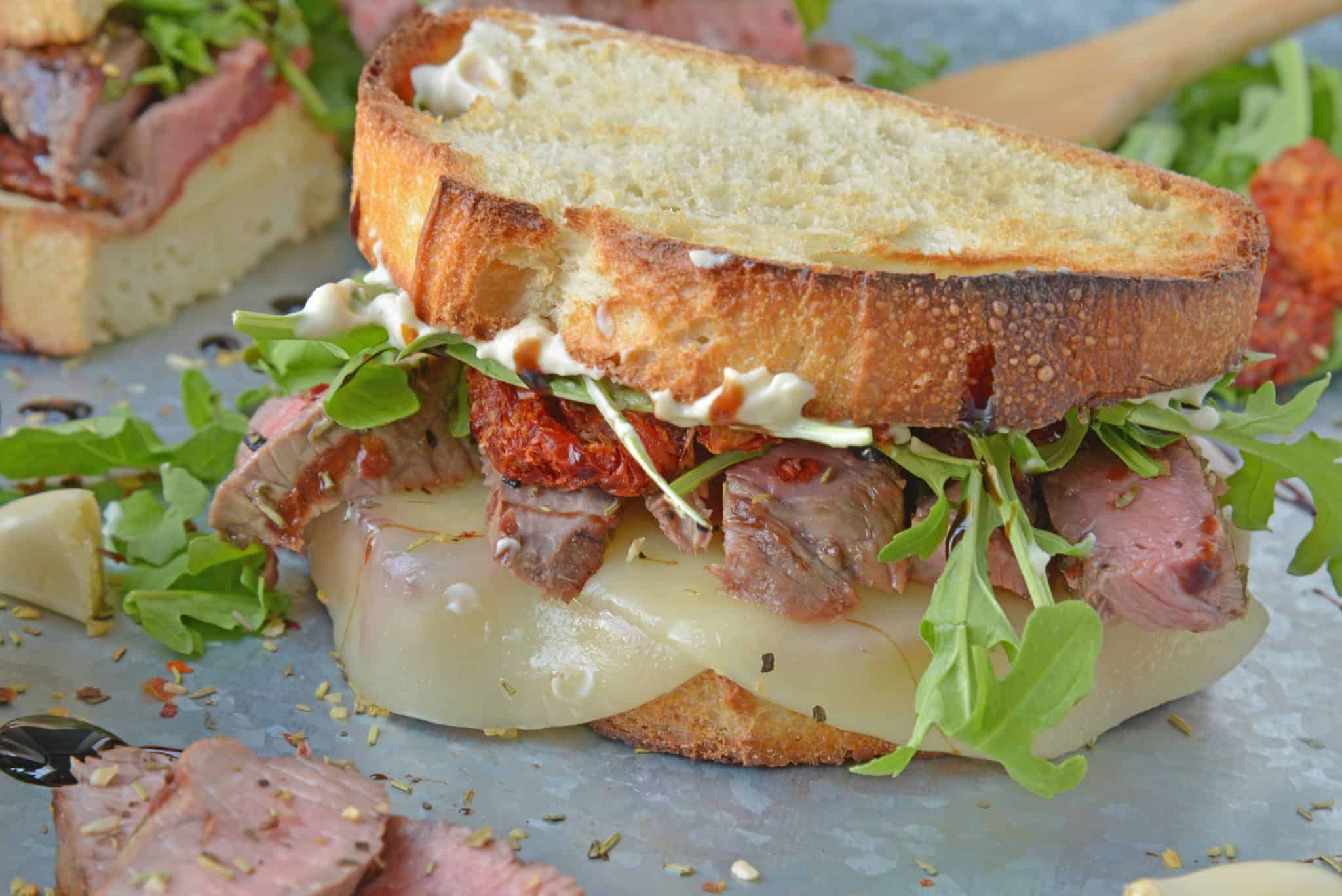 Insane Steak Sandwiches are gourmet sandwiches, seasoned to perfection with zesty Italian herbs and toppings. The best steak sandwich recipe ever! #steaksandwiches #gourmetsandwiches www.savoryexperiments.com