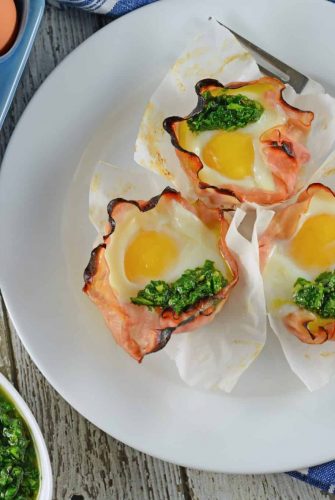 Chimichurri Egg Muffins are eggs baked in ham with a zesty chimichurri sauce made with fresh herbs and garlic. The perfect make ahead breakfast idea! #greeneggsandham #eggmuffins www.savoryexperiments.com