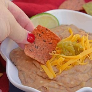 Mexican Refried Beans are an easy homemade refried bean recipe using pinto beans, green chilies, cheese and Mexican spices. Ready in just 15 minutes! #refriedbeans #mexicansidedish www.savoryexperiments.com