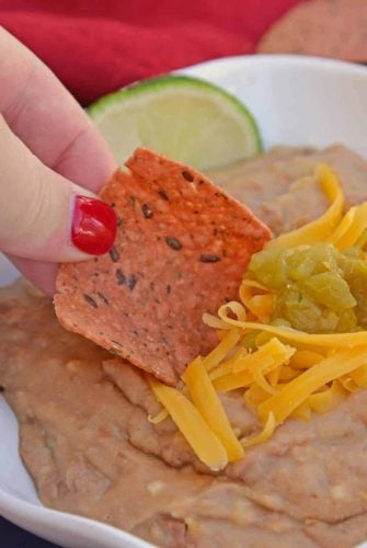 Mexican Refried Beans are an easy homemade refried bean recipe using pinto beans, green chilies, cheese and Mexican spices. Ready in just 15 minutes! #refriedbeans #mexicansidedish www.savoryexperiments.com
