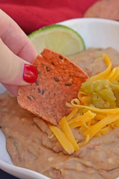 Mexican Refried Beans are an easy homemade refried bean recipe using pinto beans, green chilies, cheese and Mexican spices. Ready in just 15 minutes! #refriedbeans #mexicansidedish www.savoryexperiments.com