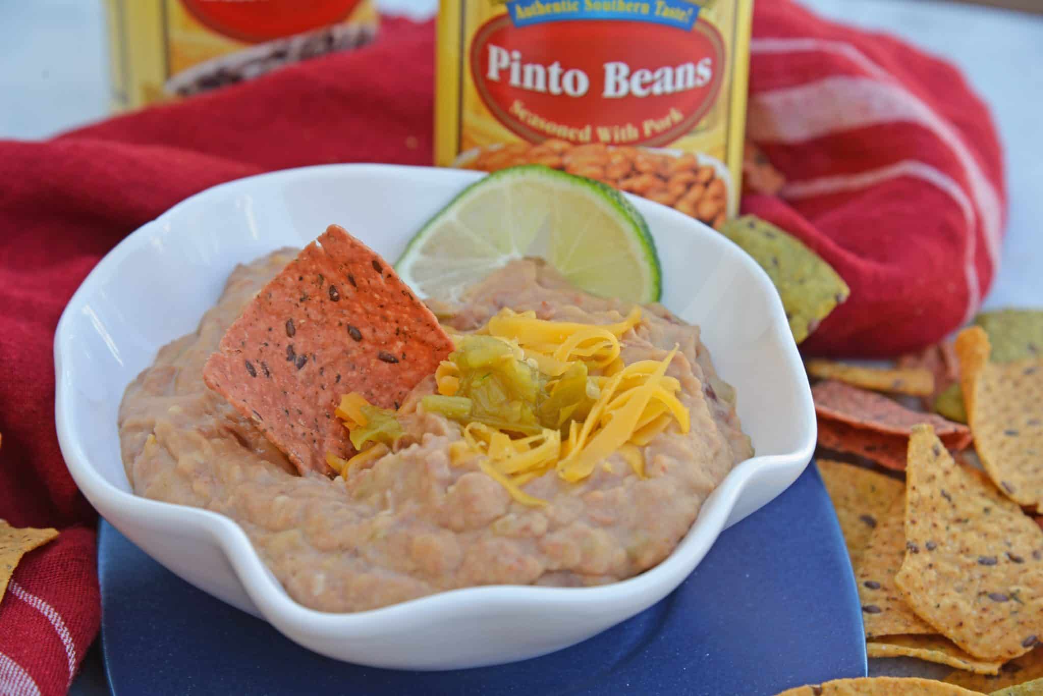 Mexican Refried Beans are an easy homemade refried bean recipe using pinto beans, green chilies, cheese and Mexican spices. Ready in just 15 minutes!