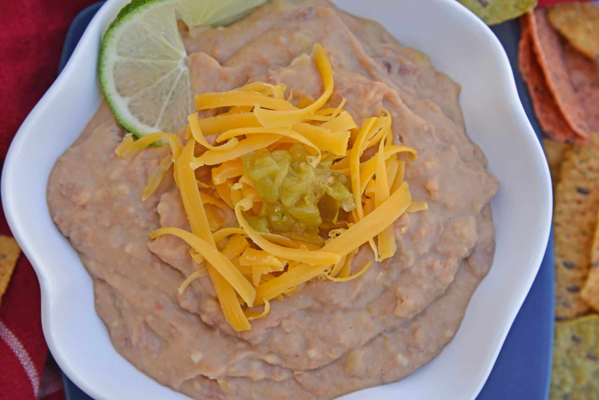 Mexican Refried Beans are an easy homemade refried bean recipe using pinto beans, green chilies, cheese and Mexican spices. Ready in just 15 minutes! #refriedbeans #mexicansidedish www.savoryexperiments.com 
