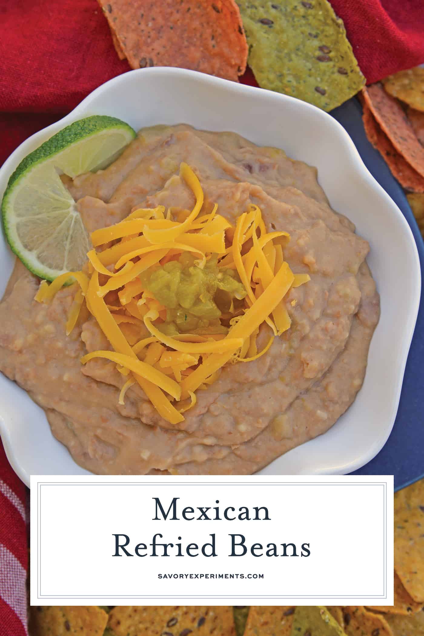 Mexican Refried Beans are an easy homemade refried bean recipe using pinto beans, green chilies, cheese and Mexican spices. Ready in just 15 minutes! #refriedbeans #mexicansidedish www.savoryexperiments.com