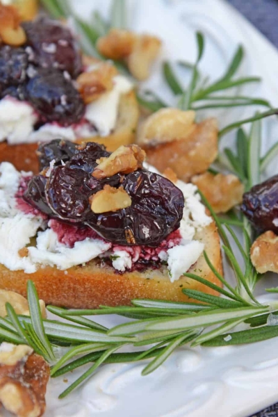 Balsamic Cherry Crostini are an easy appetizer using goat cheese and a tangy cherry balsamic reduction. The perfect holiday appetizer recipe! #crostinirecipes #goatcheeserecipes #easyappetizerrecipes www.savoryexperiments.com