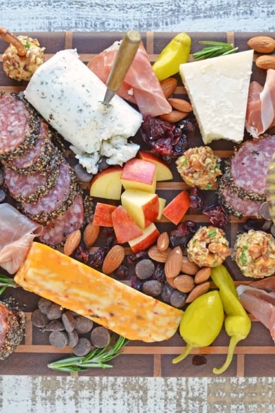 Tips for building the ultimate cheese board, the perfect easy party appetizer that requires no cooking! Ideas for meat, cheese and accompaniments. #cheeseboard #cheeseplatter www.savoryexperiments.com