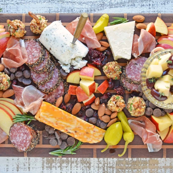 Tips for building the ultimate cheese board, the perfect easy party appetizer that requires no cooking! Ideas for meat, cheese and accompaniments. #cheeseboard #cheeseplatter www.savoryexperiments.com