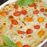 Hot Caprese Dip is a party appetizer favorite using mozzarella, pesto and sweet tomatoes. An easy appetizer your guests will love! #capresedip #capresesalad #partyappetizers www.savoryexperiments.com