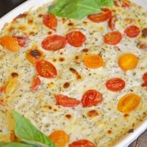Hot Caprese Dip is a party appetizer favorite using mozzarella, pesto and sweet tomatoes. An easy appetizer your guests will love! #capresedip #capresesalad #partyappetizers www.savoryexperiments.com