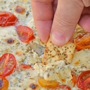 Hot Caprese Dip is a party appetizer favorite using mozzarella, pesto and sweet tomatoes. An easy appetizer your guests will love! #capresedip #capresesalad #partyappetizers www.savoryexperiments.com