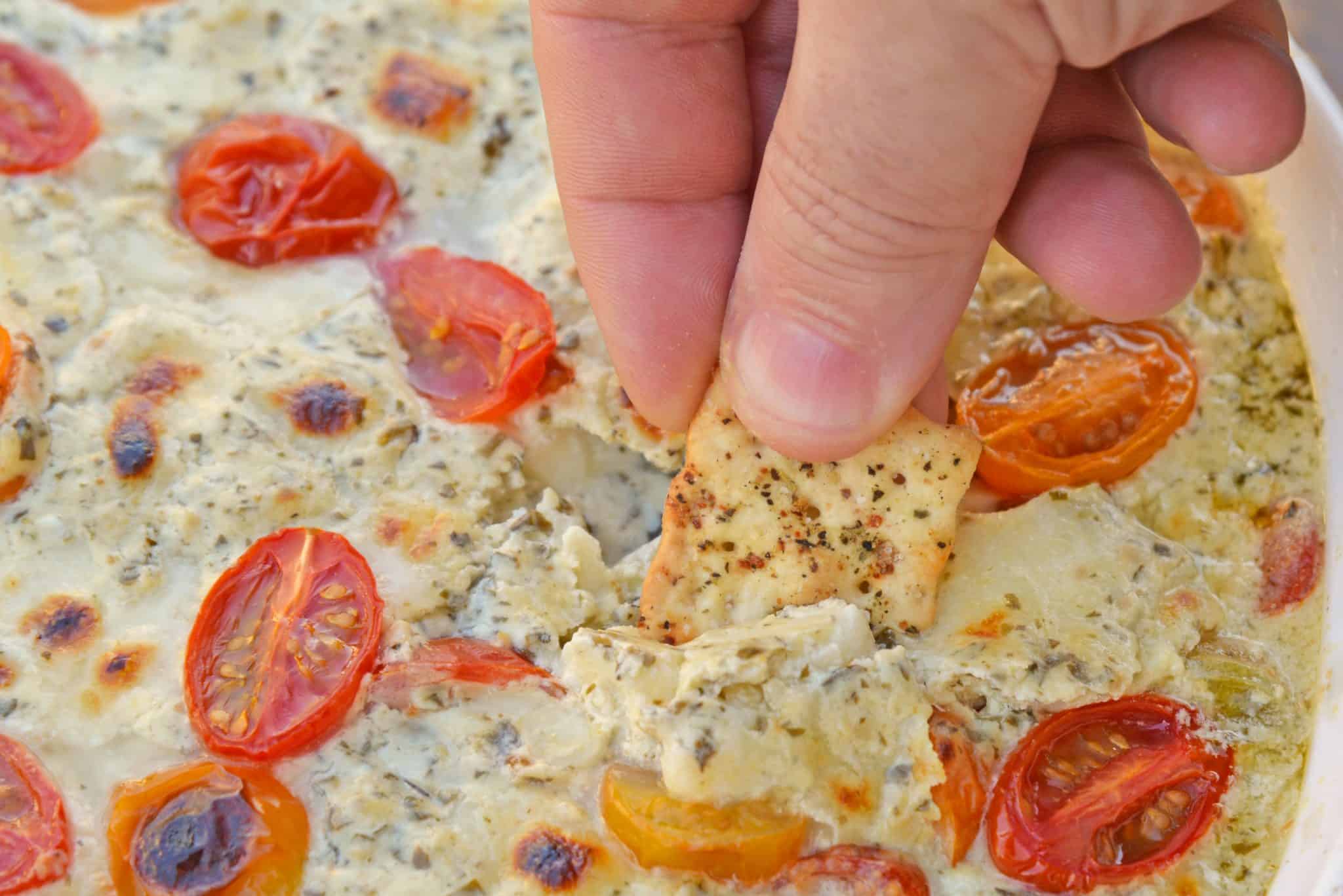 Hot Caprese Dip is a party appetizer favorite using mozzarella, pesto and sweet tomatoes. An easy appetizer your guests will love! #capresedip #capresesalad #partyappetizers www.savoryexperiments.com