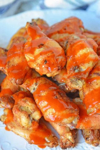 Crispy Baked Buffalo Wings are easier to make than you think. Only 5 ingredients, a simple buffalo sauce and the trick for seriously crispy wings! #bakedbuffalowings www.savoryexperiments.com