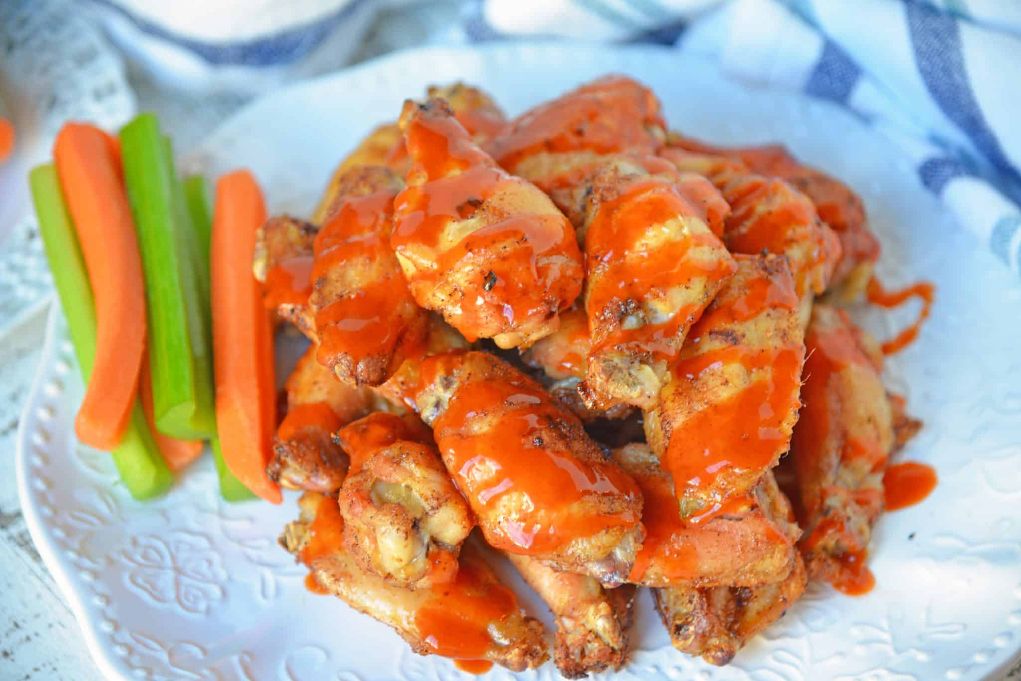 Plate of buffalo wings with carrots and celery 
