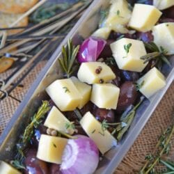 Marinated Cheese is the perfect hostess or homemade holiday gift. Simple and tasty, it also makes an easy party appetizer! #marinatedcheese #easypartyappetizers #homemadegifts www.savoryexperiments.com