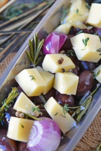 Marinated Cheese is the perfect hostess or homemade holiday gift. Simple and tasty, it also makes an easy party appetizer! #marinatedcheese #easypartyappetizers #homemadegifts www.savoryexperiments.com