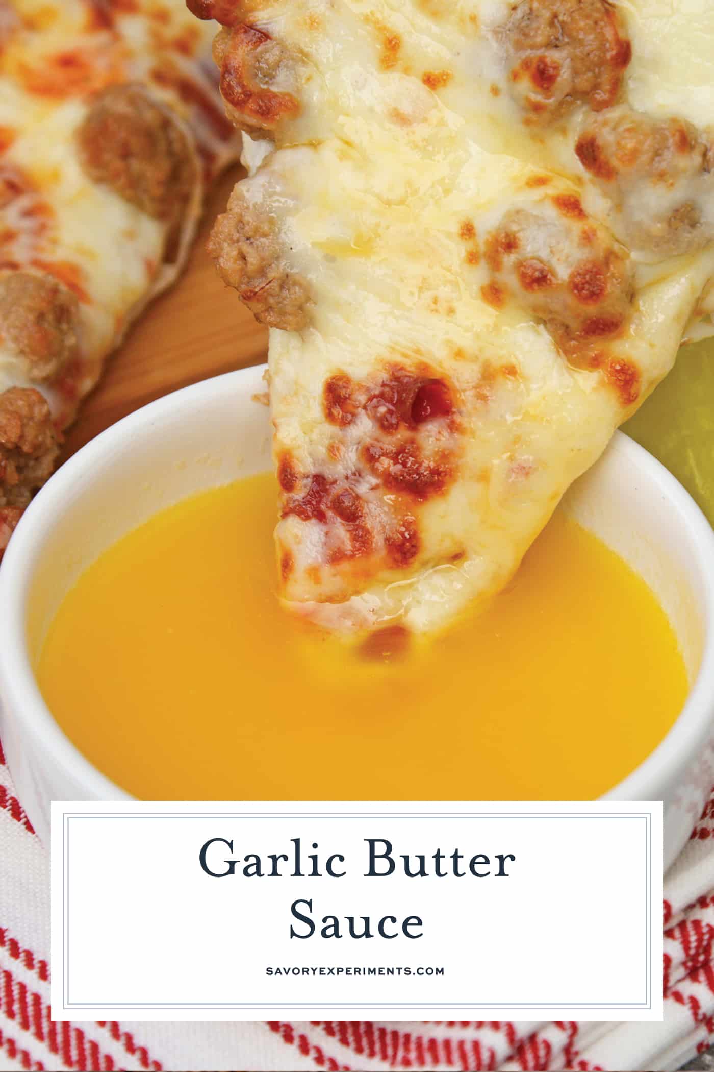 Pizza dipping into garlic butter sauce
