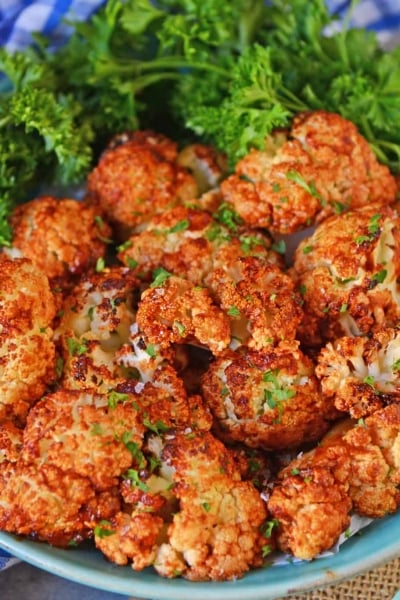 BBQ Cauliflower Bites make a healthy and quick appetizer or side. Make them zesty, tangy or even sweet! #cauliflowerrecipes #bbqcauliflowerbites www.savoryexperiments.com