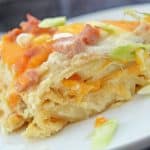 Pierogi Casserole takes your favorite pierogi and layers them with creamy ricotta, smoky kielbasa and cheddar cheese. A family favorite and great for potlucks and parties! #pierogicrecipe #casserolerecipes www.savoryexperiments.com