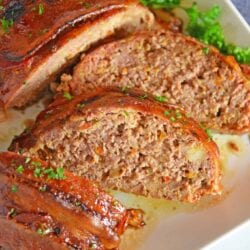 Guinness and Cheddar Meatloaf is packed with vegetables simmered in stout beer and fresh sage topped with crispy bacon and a sweet molasses glaze. #baconwrappedmeatloaf #easymeatloafrecipes www.savoryexperiments.com