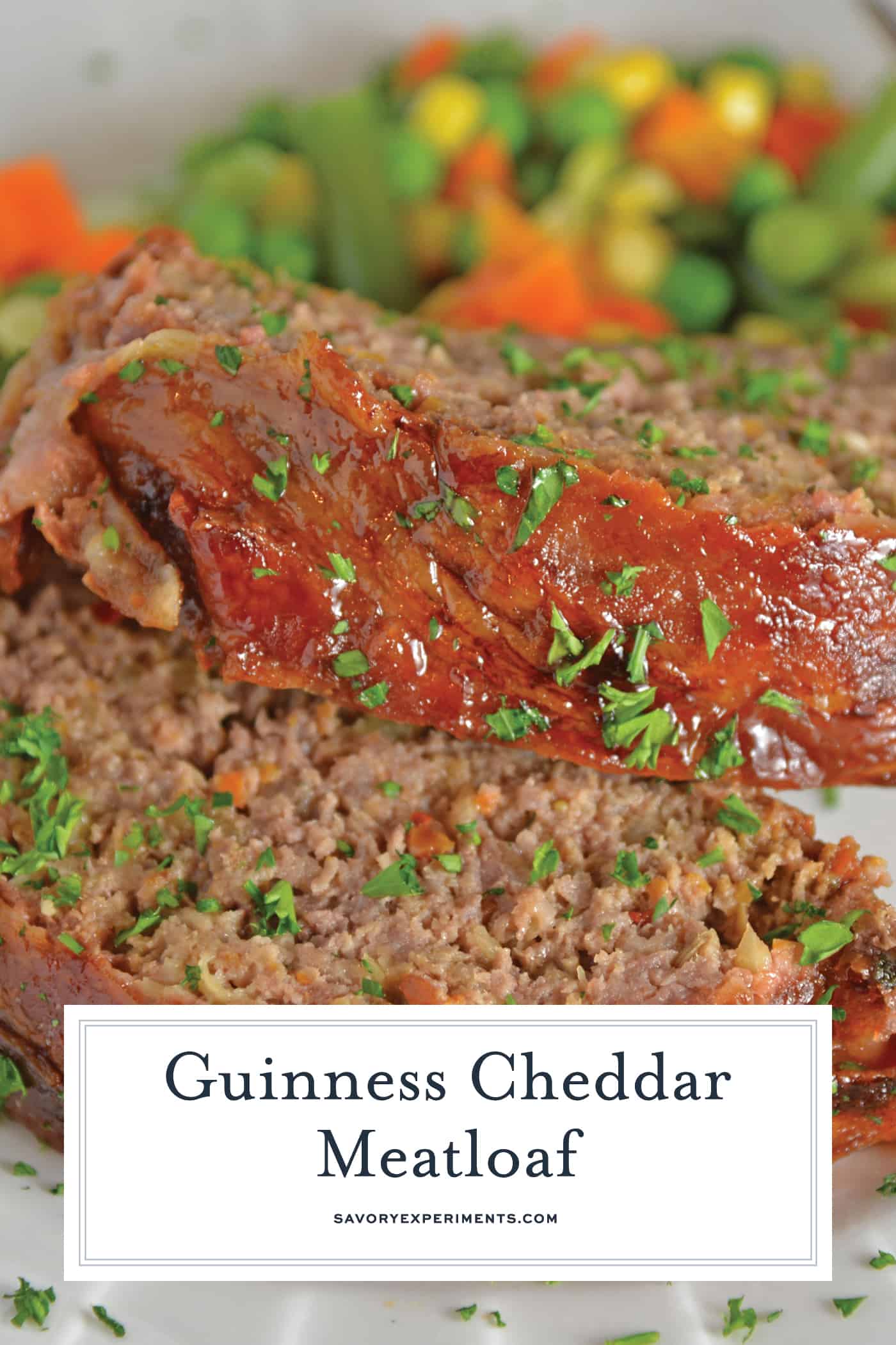 Guinness and Cheddar Meatloaf is packed with vegetables simmered in stout beer and fresh sage topped with crispy bacon and a sweet molasses glaze. #baconwrappedmeatloaf #easymeatloafrecipes www.savoryexperiments.com